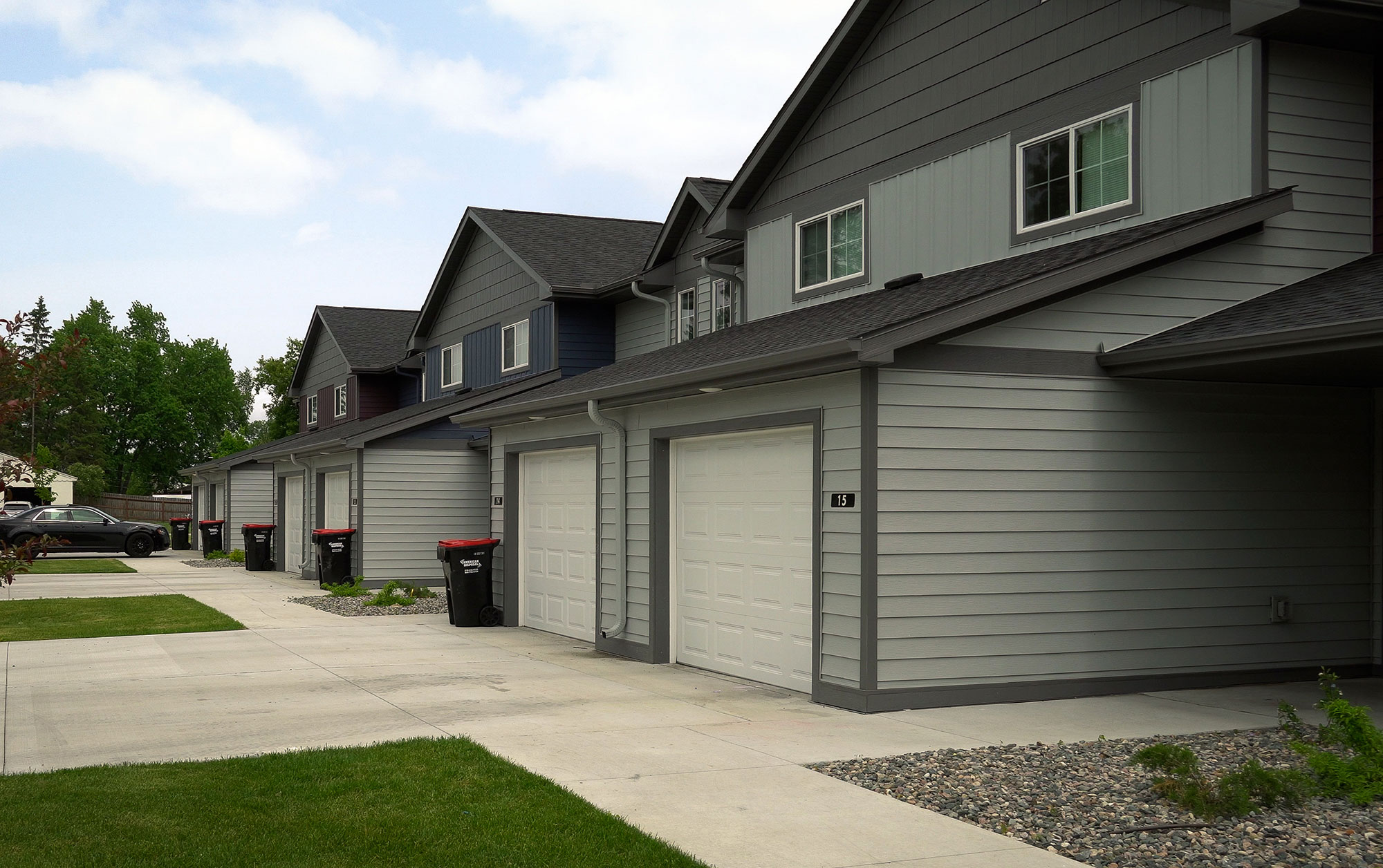 Townhomes with trash bins against garage