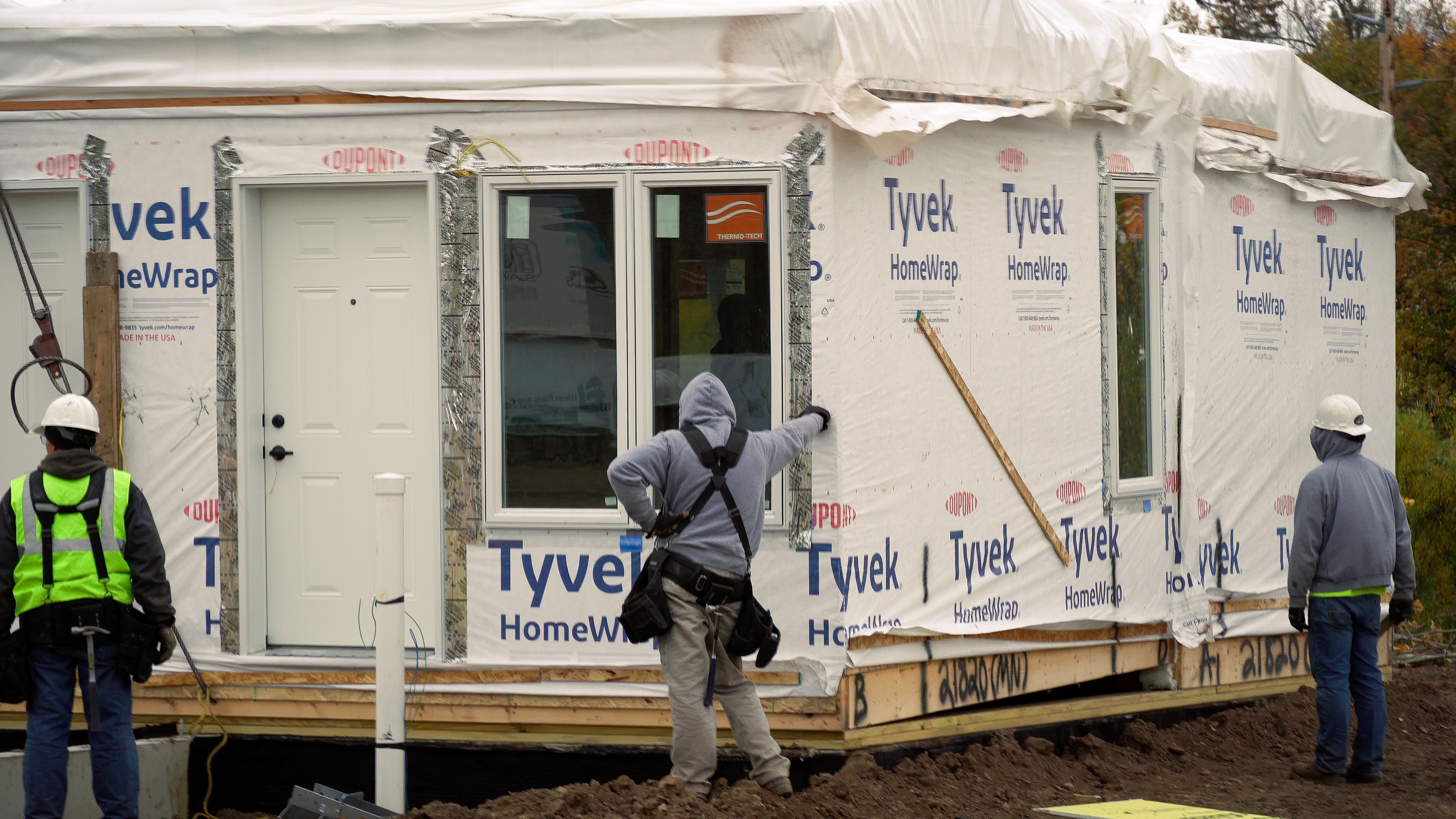 Construction crew assembling a modular home