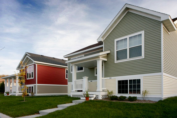 red and beige single-family houses at Heritage Greens