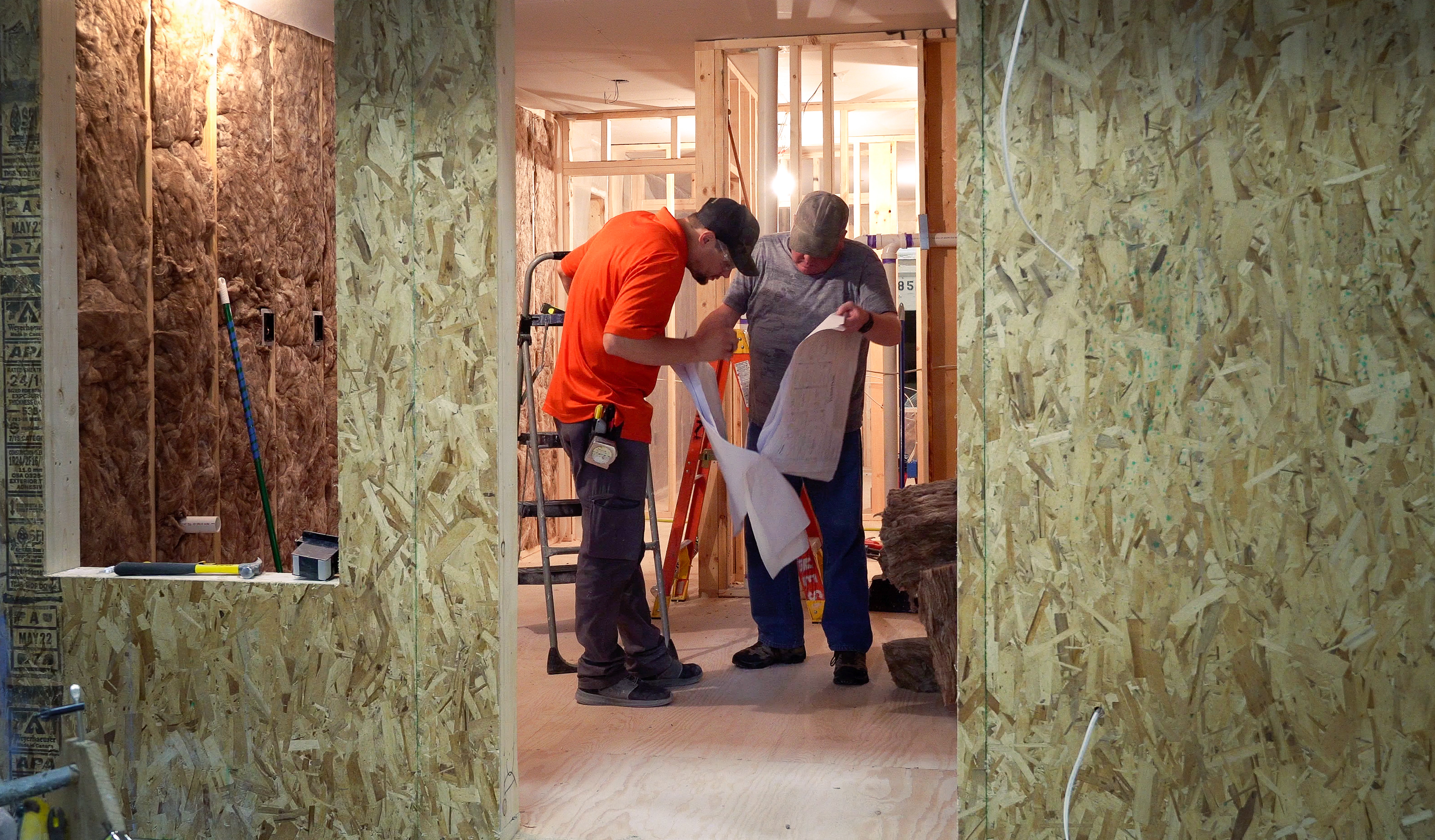 Men_looking_at_plans_in_house_being_built